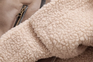 Detail of vintage suede jacket with warm white fleece lining and brass metal zipper