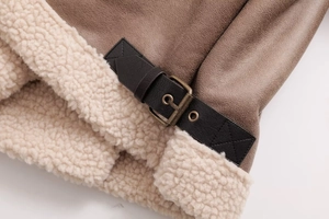 Detail of faux suede jacket with cream shearling trim and black leather strap buckle