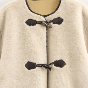 Women's cream faux fur coat with brown leather toggle closure and round neck design