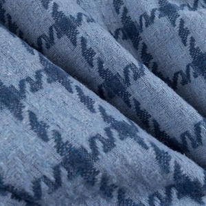 Detailed macro view of the premium blue houndstooth woven fabric and thick wool texture
