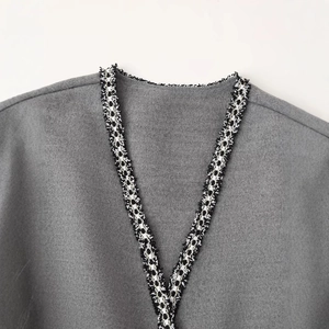Grey wool blend coat featuring V-neckline with black and white woven ribbon trim detail