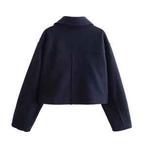 Back view of a navy blue cropped wool jacket featuring a minimalist yoke and clean seams