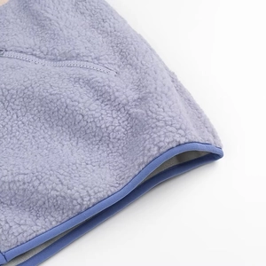 Detail of lavender fleece jacket showing high-quality zipper pocket and blue contrast piping