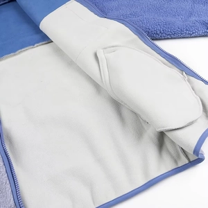 Detail of soft white fleece lining and internal pocket on the blue fleece jacket