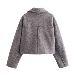 Detailed back view of dark grey cropped tweed jacket showing fabric texture and seams