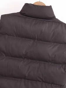 Detail of the high windproof stand collar and horizontal quilting on this padded vest