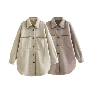 Detail of loose-fit wool blend shackets with contrast stitching and front pockets