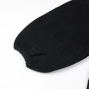 Close-up of ribbed cuffs on high-density black knit cardigan sweater for women