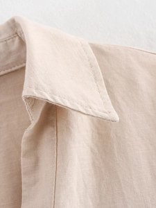Detailed macro view of beige cotton linen lapel collar with premium stitching texture