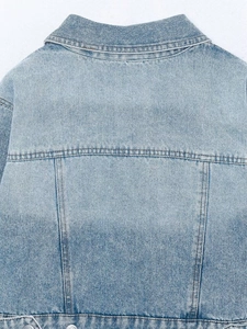 Detail shot of light blue denim jacket back with contrast stitching and washed texture