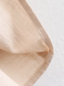 Detailed close-up showing the high-quality linen texture and refined edge stitching of the set
