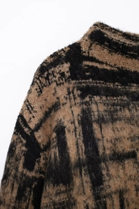 Detail of premium fuzzy knit fabric with abstract brown and black textured pattern