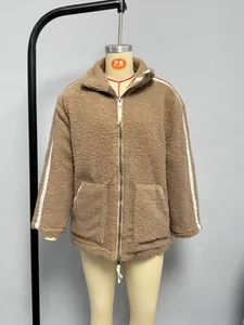 Detailed close-up of brown sherpa fleece jacket with high collar and white stripes