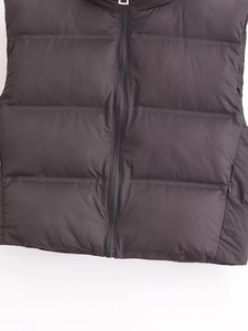Detailed close-up of high-quality zipper and quilted texture on a black puffer vest