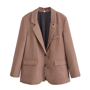 Detail of classic brown houndstooth blazer with notched lapels and flap pockets