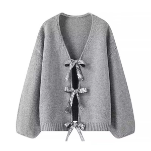 Chic grey knit cardigan with sequined bow closures and cozy oversized ribbed texture