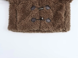 Macro view of brown faux fur texture and horn toggles on the winter coat