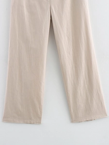 Detail shot of light beige linen blend wide-leg trousers showing natural fabric texture