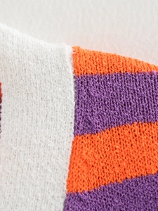 Macro detail of soft terry cloth fabric with orange and purple stripes on white knitwear