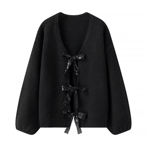 Women's black V-neck knit cardigan sweater featuring three sequined bow tie closures