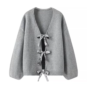 Women's grey knit cardigan with silver sequin bow ties and a stylish V-neck design