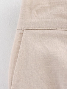 Detail of beige linen fabric texture and side pocket stitching for casual women sets