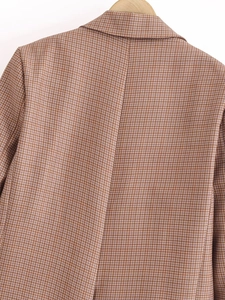 Detail of classic houndstooth plaid pattern on a women blazer collar and shoulder