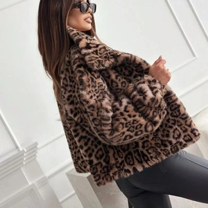 Detail of faux fur cropped jacket with leopard print pattern worn by a model