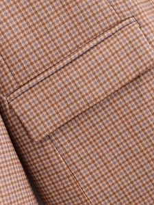 Detailed view of the plaid pattern and high-quality stitching on the pocket of the blazer