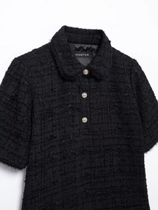 Close-up of black tweed short sleeve top with vintage gold buttons and Peter Pan collar