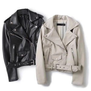 Detail of faux leather biker jackets in black and cream with metal zippers and belt