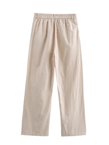 Detail showing elastic waistband and back pocket on beige linen blend straight-leg pants