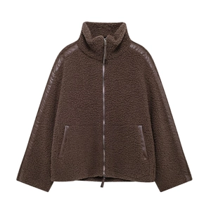 Detail view of brown teddy fleece jacket with leather piping and metal zipper closure