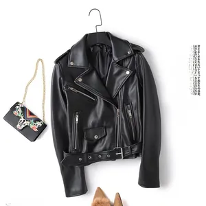 Close-up of black PU leather biker jacket with silver zippers and floral embroidered bag