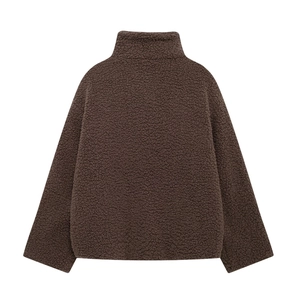 Detail view of brown fleece jacket showing textured lamb wool fabric and stand collar