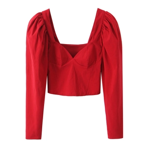 Detailed view of red puff sleeve crop top with structured bodice and square neckline
