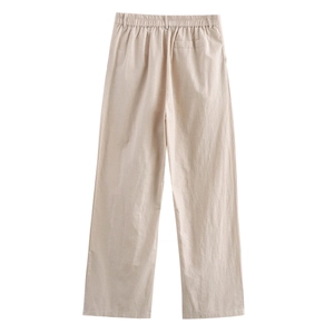 Detail of high-waisted beige linen wide-leg trousers with elastic waistband and back pocket