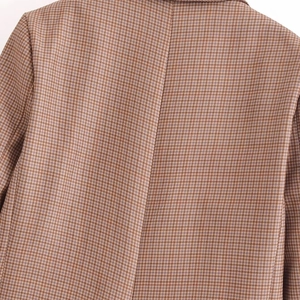 Back view of a classic brown houndstooth blazer showing shoulder seams and premium fabric texture