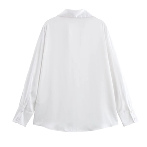 Detail view of smooth white satin shirt back with long sleeves and buttoned cuffs