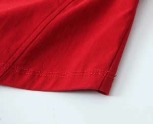 Close-up of double-needle hem stitching on red long sleeve French vintage knit top
