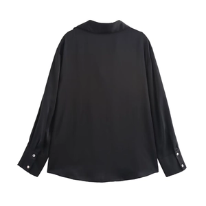 Rear view detail of a black satin long sleeve shirt with smooth silk texture and buttons