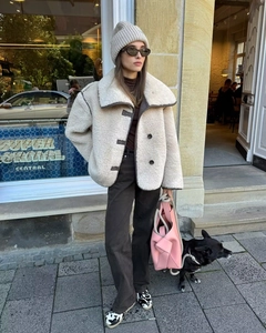 Detail of faux fur aviator jacket with contrast piping and large lapel collar