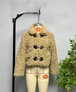 Detail of khaki fleece jacket featuring gold metal toggles and black leather closures