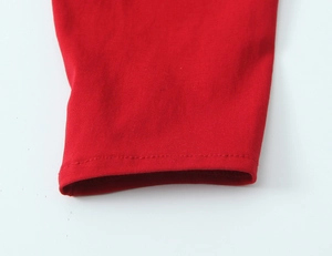 Detail of red French retro puff sleeve top showing neat stitching and knit texture