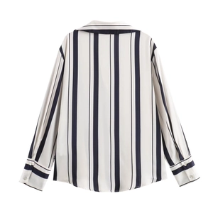 Detail of classic vertical stripe pattern on white long sleeve satin shirt for women