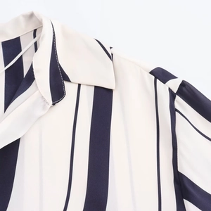 Detail shot of navy and cream vertical striped satin shirt showing collar and stitching
