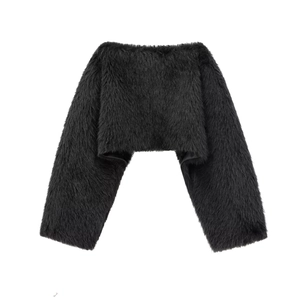 Detail of black faux fur bolero featuring long fluffy textures and silky inner lining