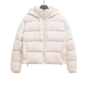 Macro detail of cream hooded puffer jacket featuring horizontal quilting and drawstrings