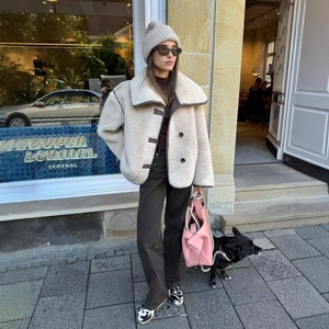 Women's chic beige faux shearling jacket with large lapels and dark button accents