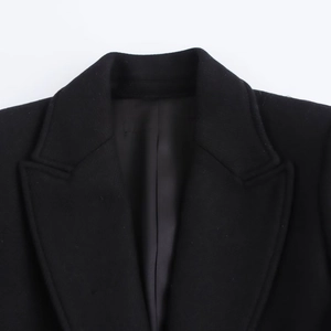 Close-up of black notched lapel wool coat with professional double stitching details